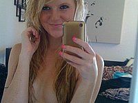 Sexy Blondine fotografiert sich mit ihrem Handy