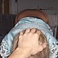 Blonder Blasehase mit dem Schwanz im Mund
